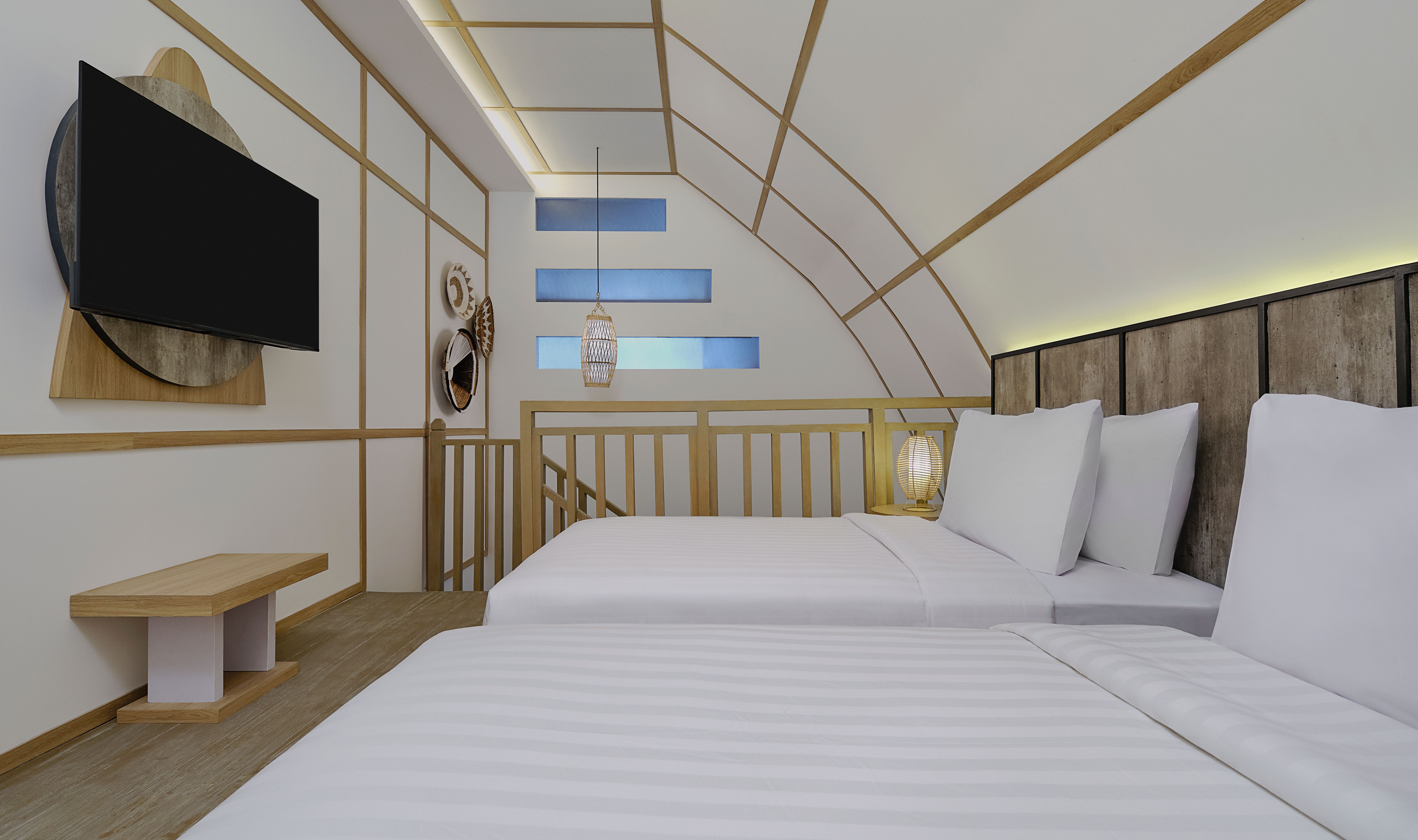 Twin slaapkamer boven in de Family Suite Duplex in Jambuluwuk Ocean Boutique Resort op Gili Trawangan