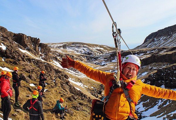 IJsland-Vik-Zipline-vrouw-zwaait-naar-camera